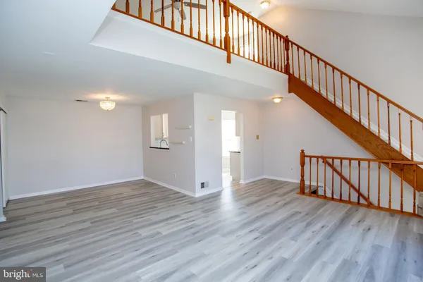 a view of room with wooden floor and windows