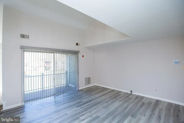 a view of a room with wooden floor and fan