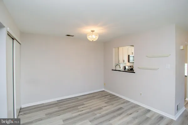 a kitchen with stainless steel appliances granite countertop a stove a refrigerator and a microwave