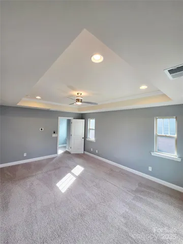 a view of empty room with window and lamp
