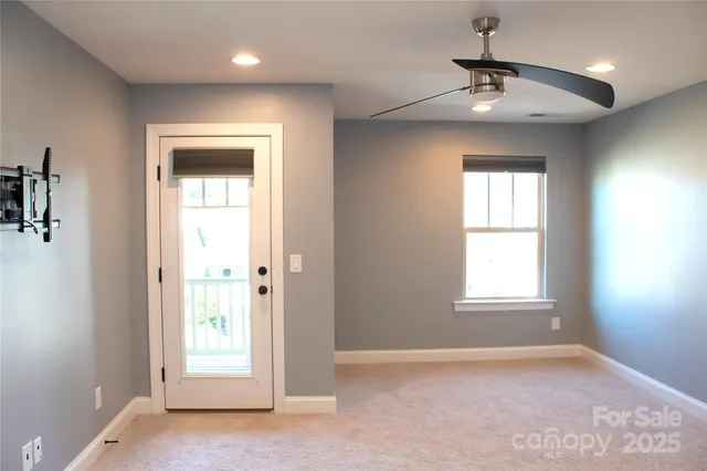 an empty room with windows and closet