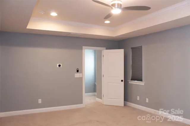 an empty room with closet and fan