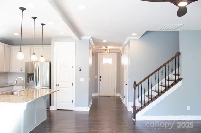 a view of a kitchen with a sink and a wooden floor