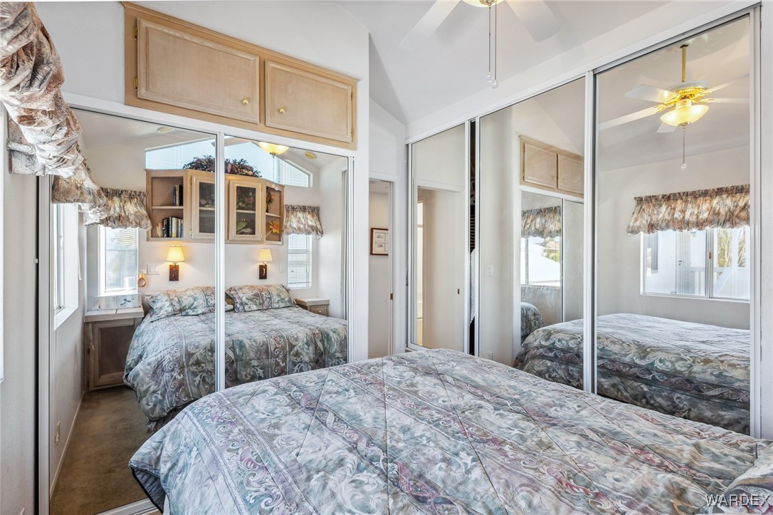 2000 Ramar Road, Unit 211 Bullhead City, AZ 86442 - Photo 15 of 57 Primary bedroom featuring mirrored closet doors and built-ins.