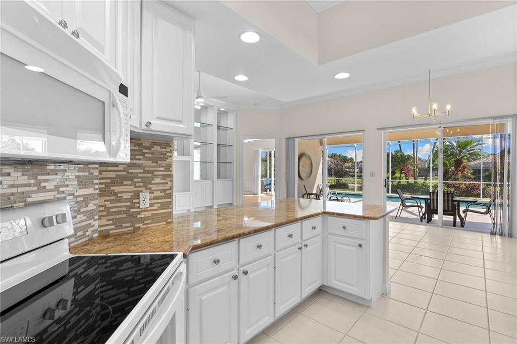 3128 Dominica Way Naples, FL 34119 - Photo 13 of 45 a kitchen with a sink and cabinets