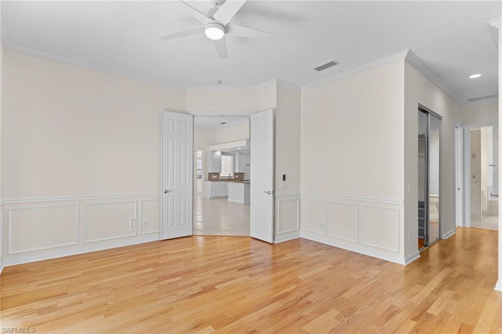 3128 Dominica Way Naples, FL 34119 - Photo 17 of 45 a view of empty room with wooden floor and fan
