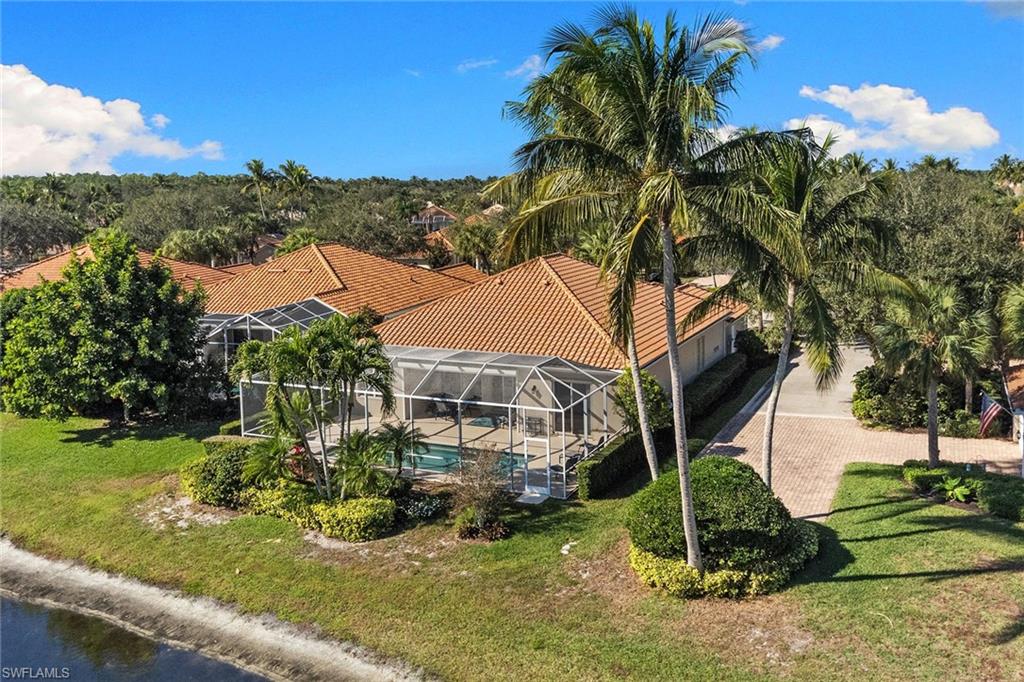 3128 Dominica Way Naples, FL 34119 - Photo 2 of 45 a view of a house with a yard