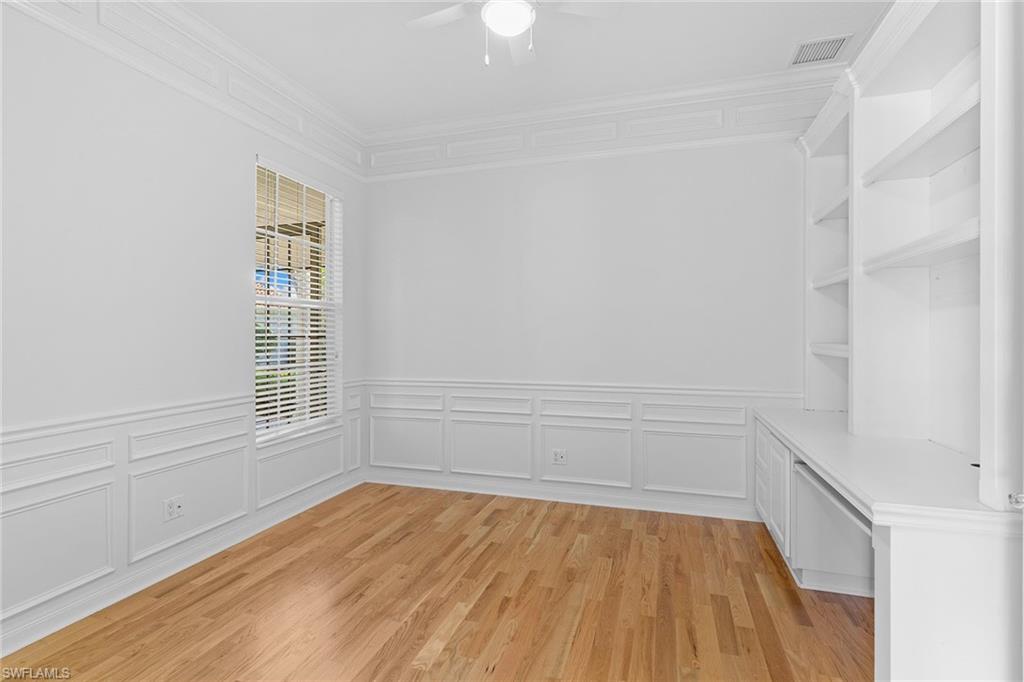 3128 Dominica Way Naples, FL 34119 - Photo 25 of 45 a view of an empty room with wooden floor and a window