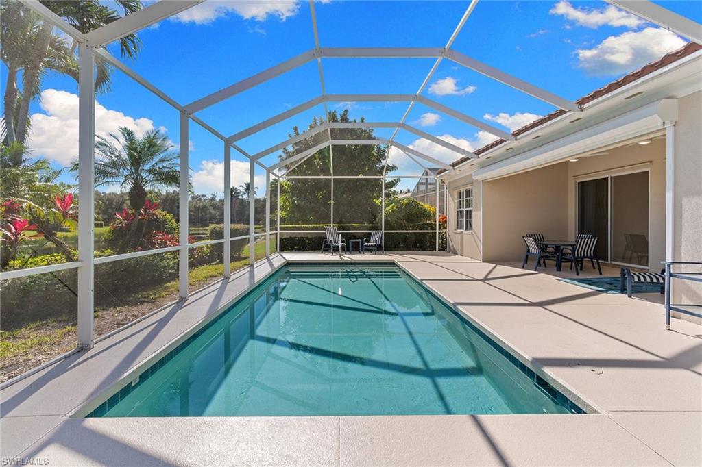 3128 Dominica Way Naples, FL 34119 - Photo 31 of 45 a view of a backyard with a swimming pool