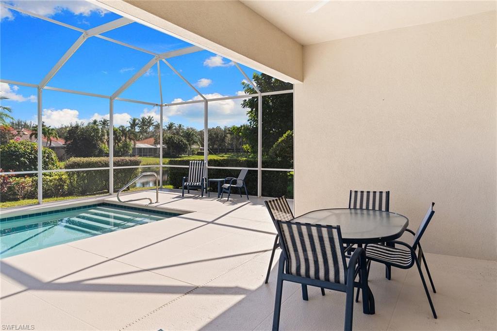 3128 Dominica Way Naples, FL 34119 - Photo 32 of 45 a view of a chair and table on the deck