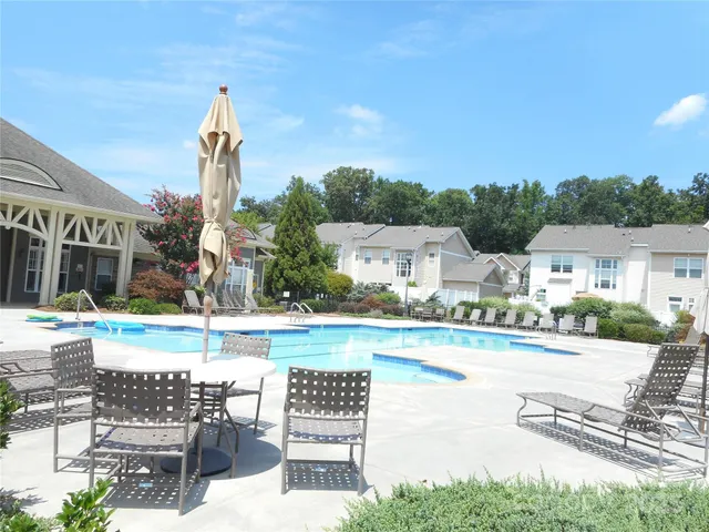 a view of a house with a yard and table and chairs