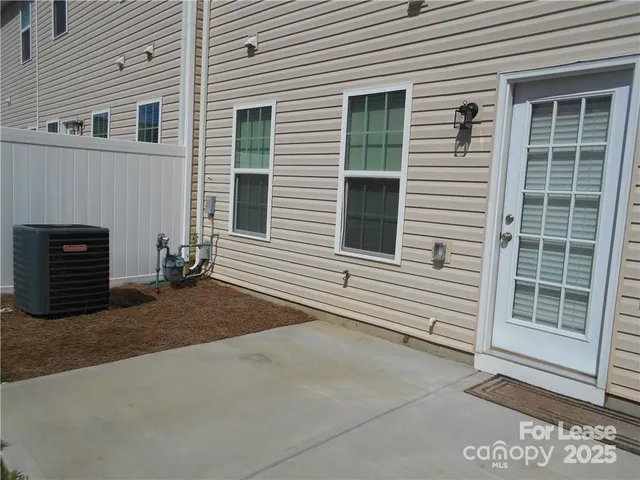 a view of a house with white door and a window