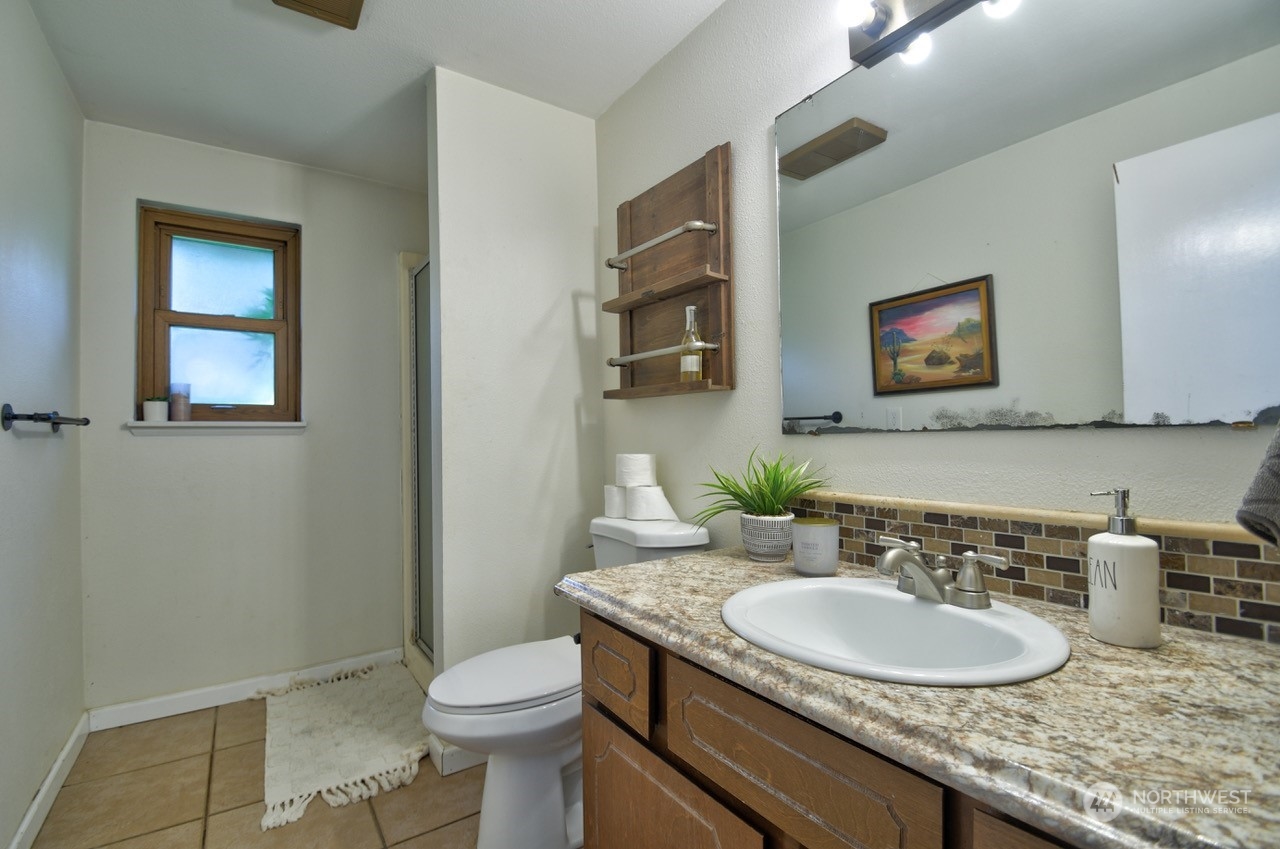 3110 Zenkner Valley Road Centralia, WA 98531 - Photo 17 of 40 a bathroom with a granite countertop toilet sink and mirror