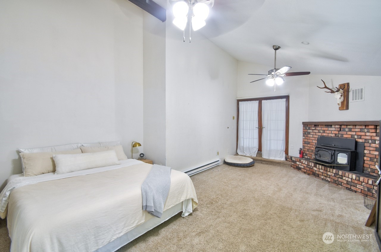 3110 Zenkner Valley Road Centralia, WA 98531 - Photo 20 of 40 a bedroom with a bed and a fireplace