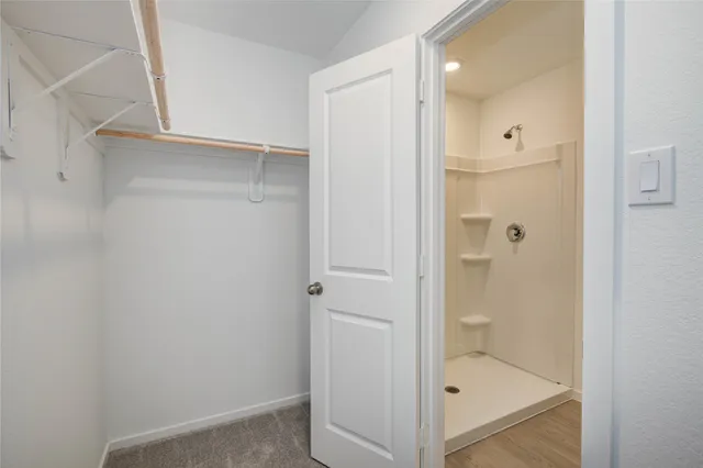 a bathroom with a glass shower door