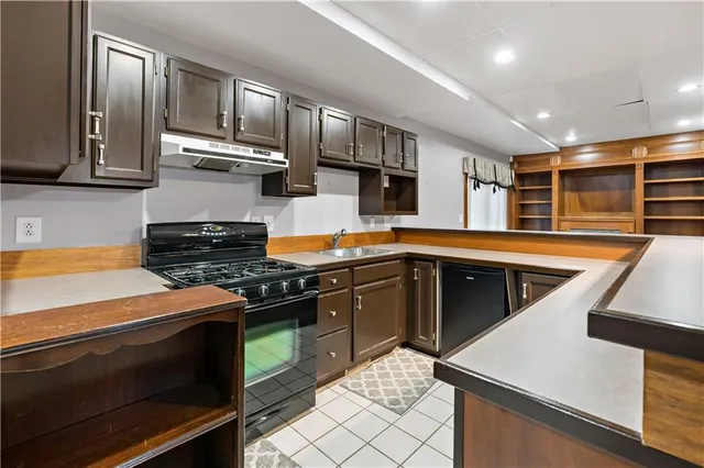 a kitchen with kitchen island a sink stove and refrigerator