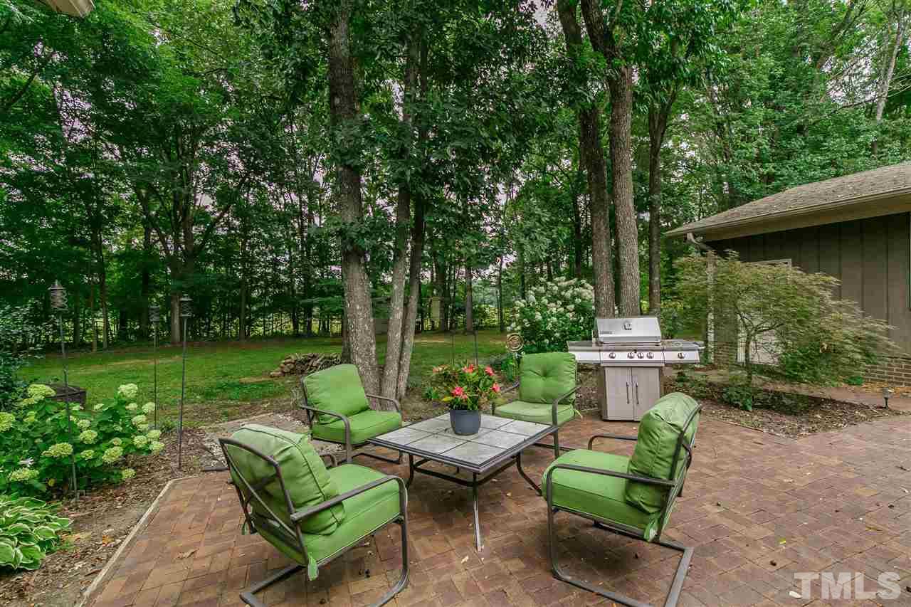 1879 Routh Road Burlington, NC 27217 - Photo 22 of 30 LOVELY brick paver patio surrounded my towering hardwoods