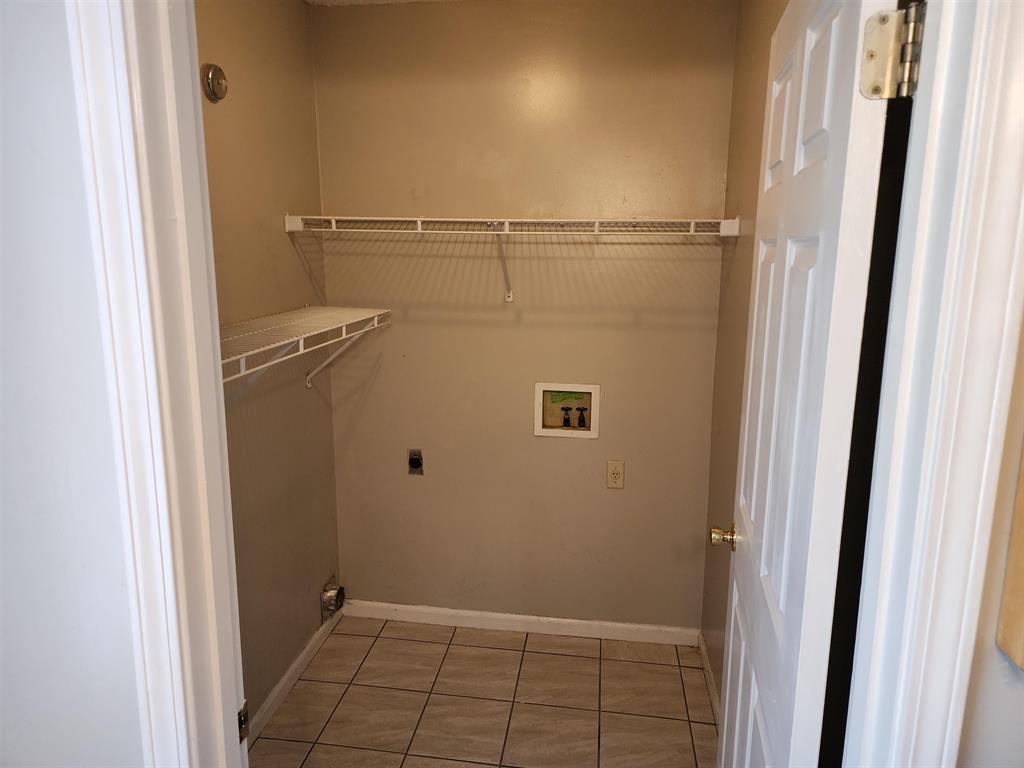 255 Windy Ridge Cove Collierville, TN 38017 - Photo 16 of 21 Laundry room with hookup for a washing machine and light tile patterned floors