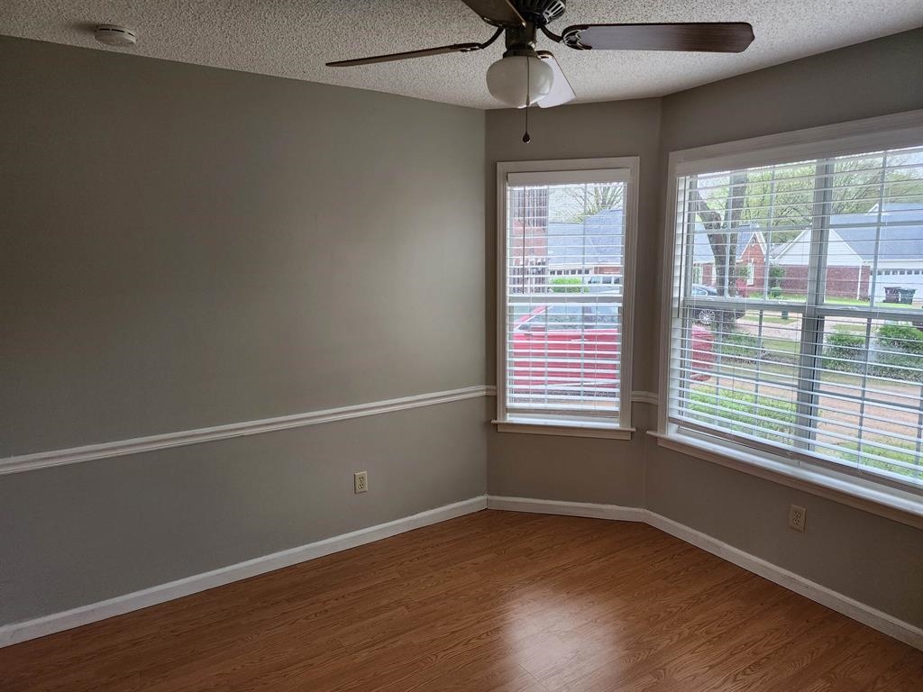 255 Windy Ridge Cove Collierville, TN 38017 - Photo 6 of 21 Spare room with dark wood-style flooring, ceiling fan, a textured ceiling, and a smoke detector