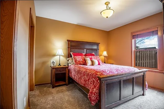 a bedroom with two beds and a window