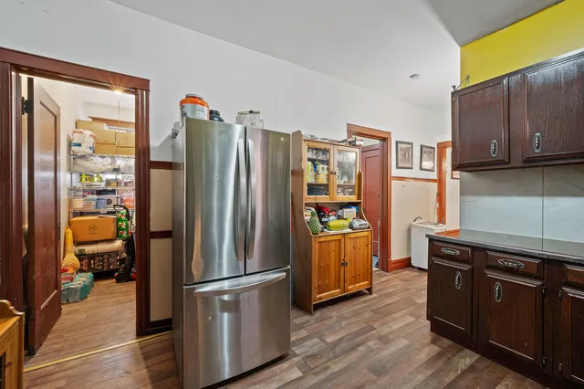 a kitchen with stainless steel appliances a refrigerator a stove a sink and a refrigerator