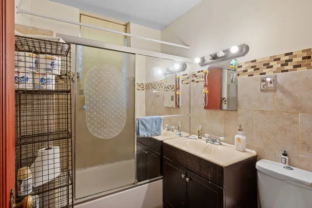 a bathroom with a double vanity sink mirror and shower