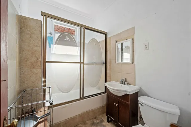 a bathroom with a toilet a sink and mirror