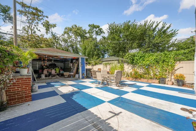 a view of a patio with table and chairs and potted plants