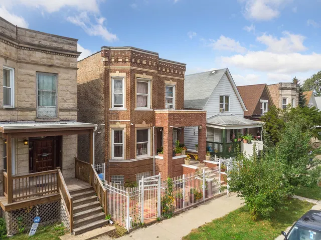 a front view of a residential apartment building with a yard