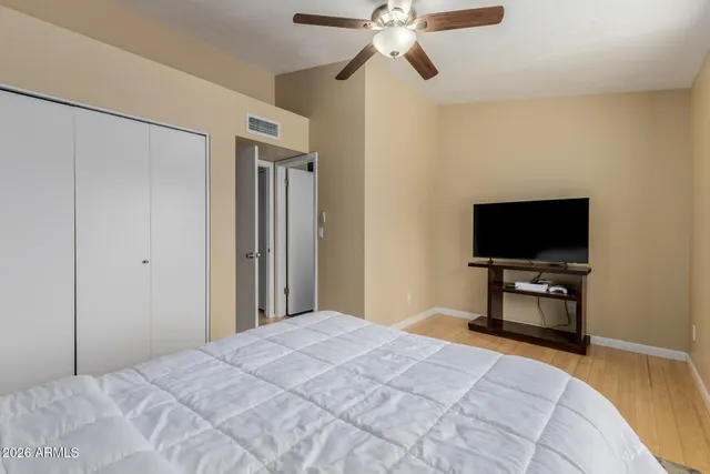 a bedroom with a bed and a flat screen tv