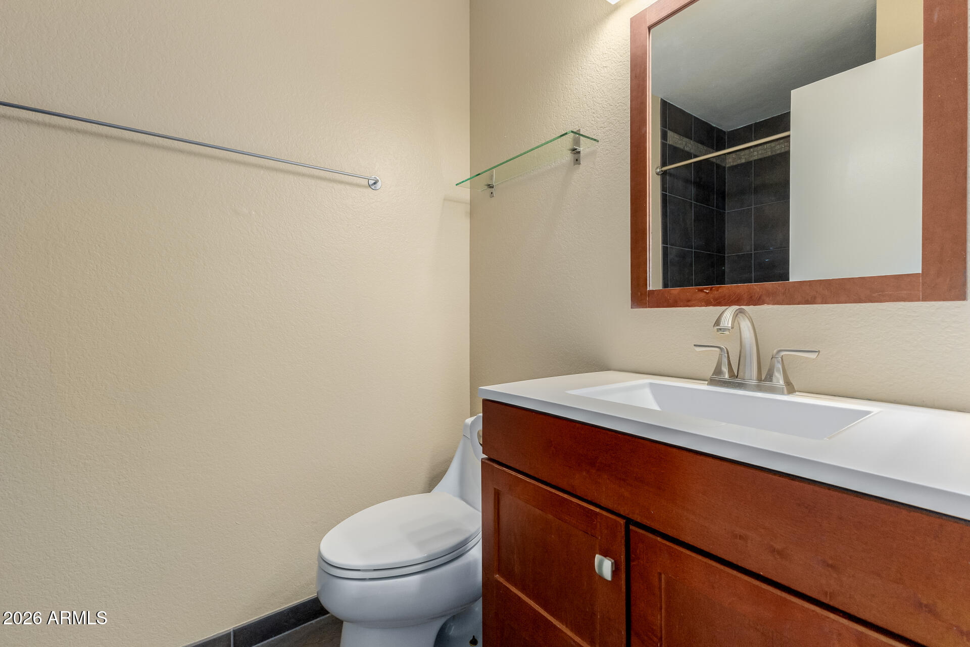 4843 East Corral Road, Unit 4 Phoenix, AZ 85044 - Photo 14 of 36 a bathroom with a granite countertop sink toilet and a mirror