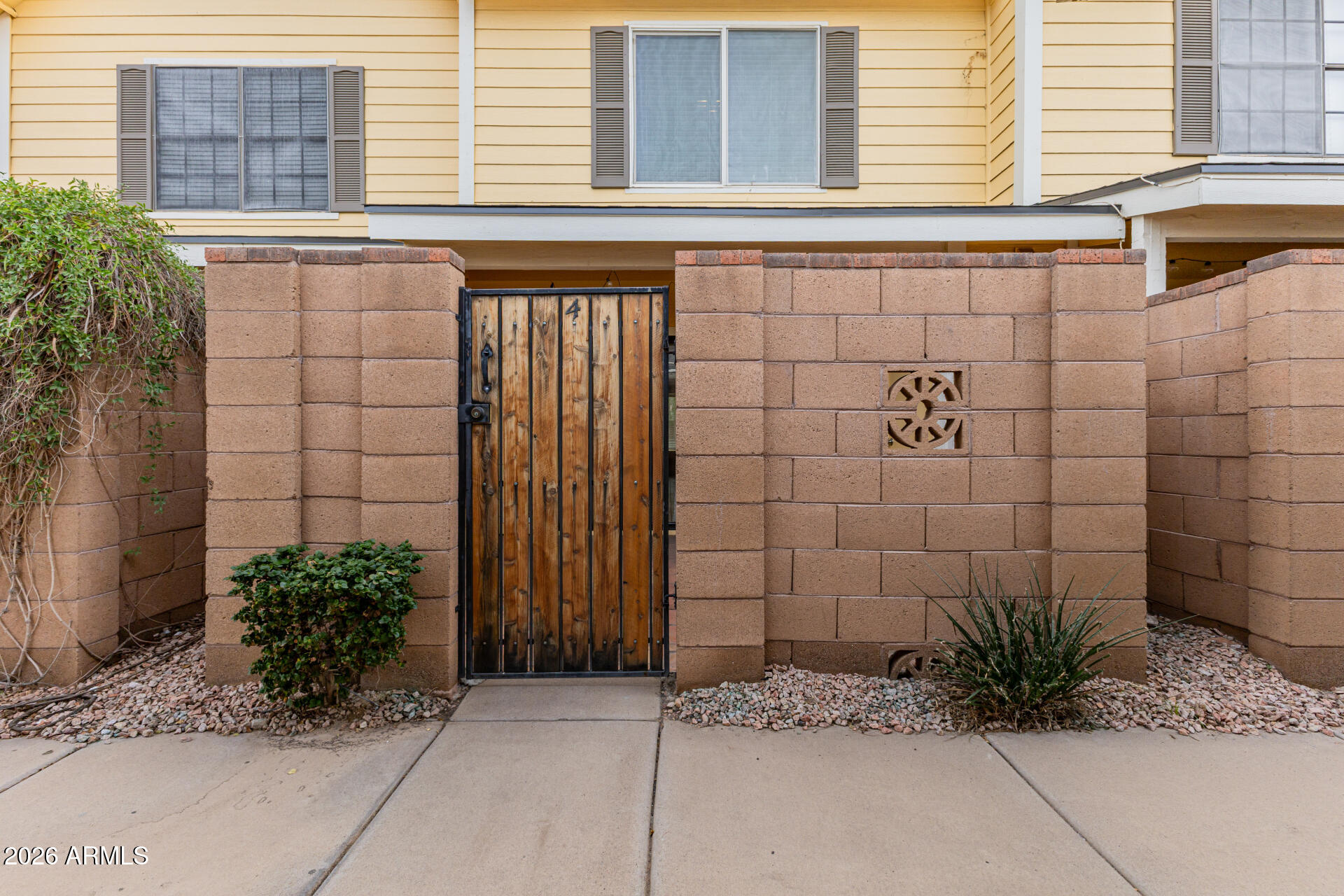 4843 East Corral Road, Unit 4 Phoenix, AZ 85044 - Photo 22 of 36 a view of a brick house with a potted plants