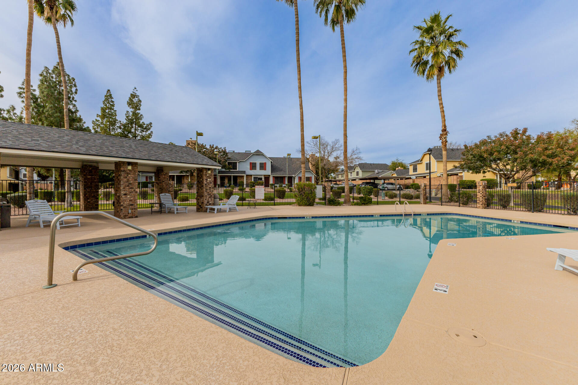 4843 East Corral Road, Unit 4 Phoenix, AZ 85044 - Photo 24 of 36 a view of a swimming pool with a table and chairs