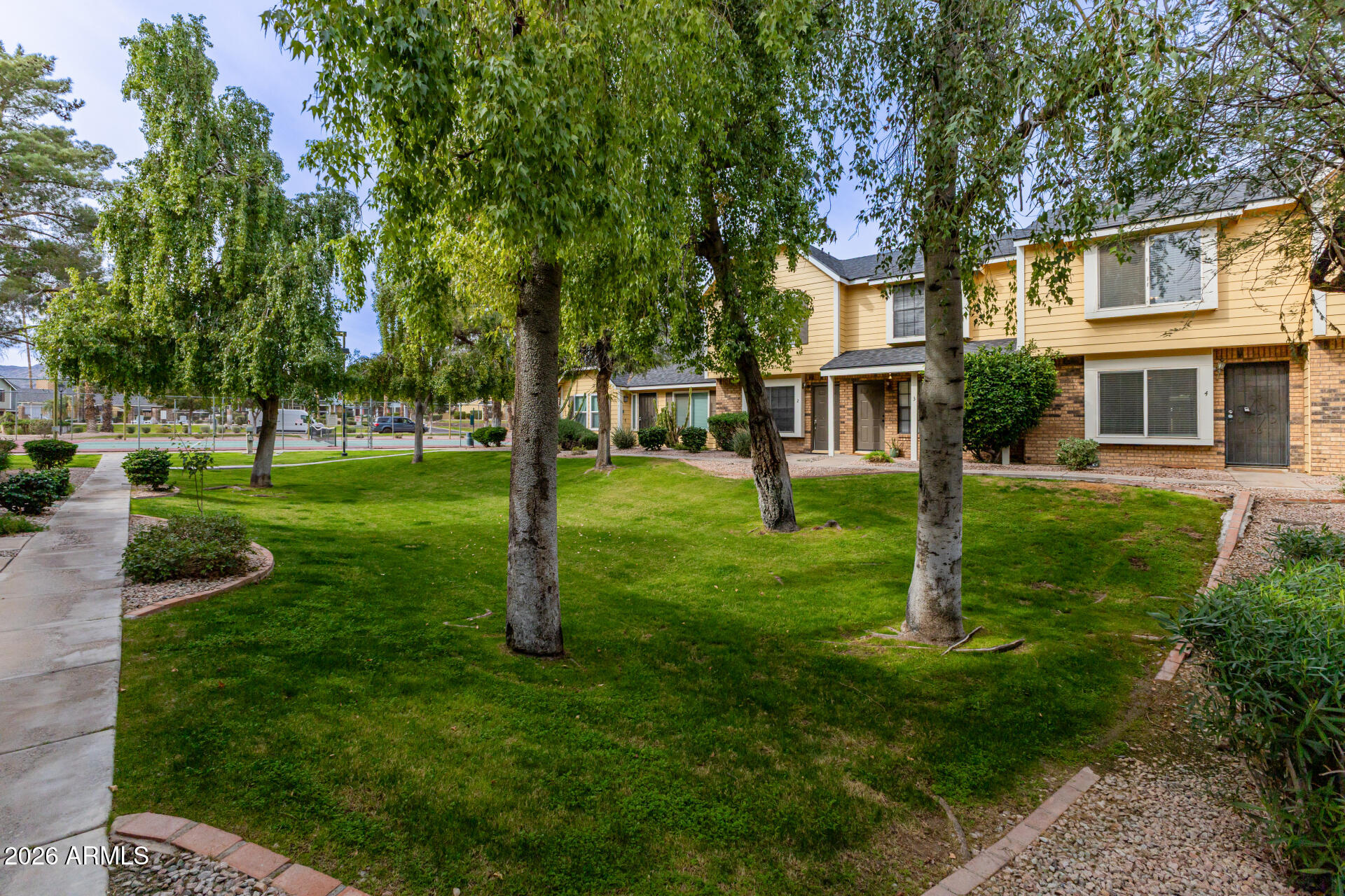 4843 East Corral Road, Unit 4 Phoenix, AZ 85044 - Photo 28 of 36 a front view of a house with a yard