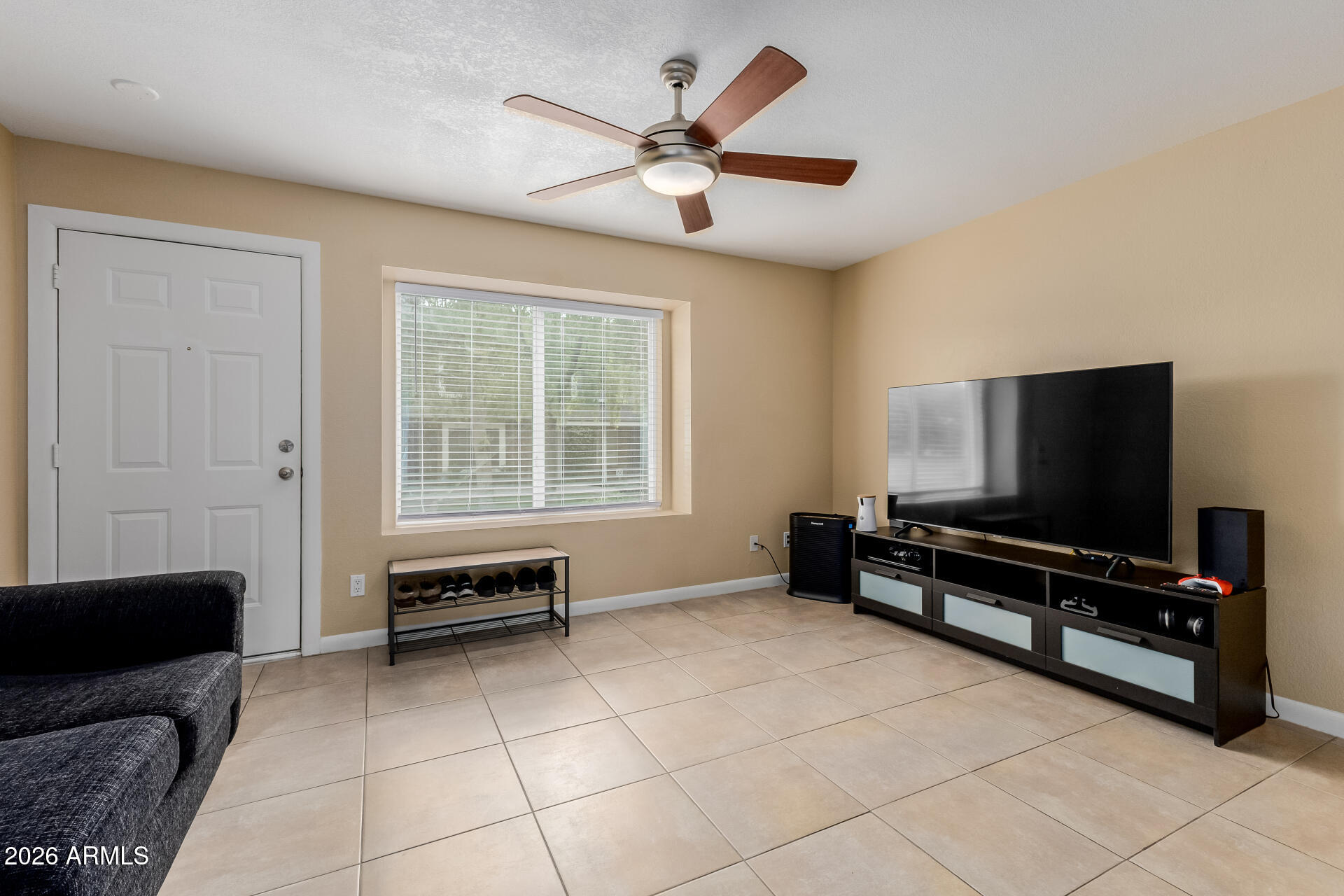 4843 East Corral Road, Unit 4 Phoenix, AZ 85044 - Photo 4 of 36 a living room with furniture and a flat screen tv
