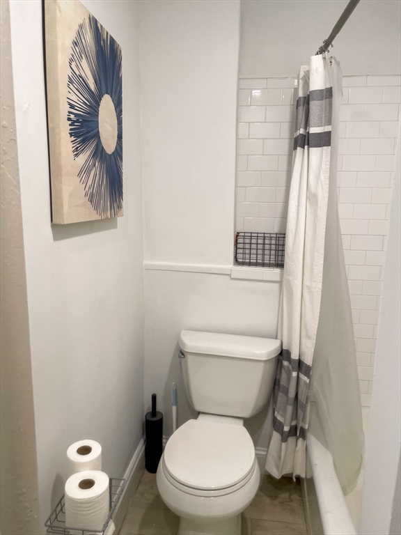 34 East Newton Street, Unit 2 Boston, MA 02118 - Photo 6 of 7 a white toilet sitting next to a shower curtain