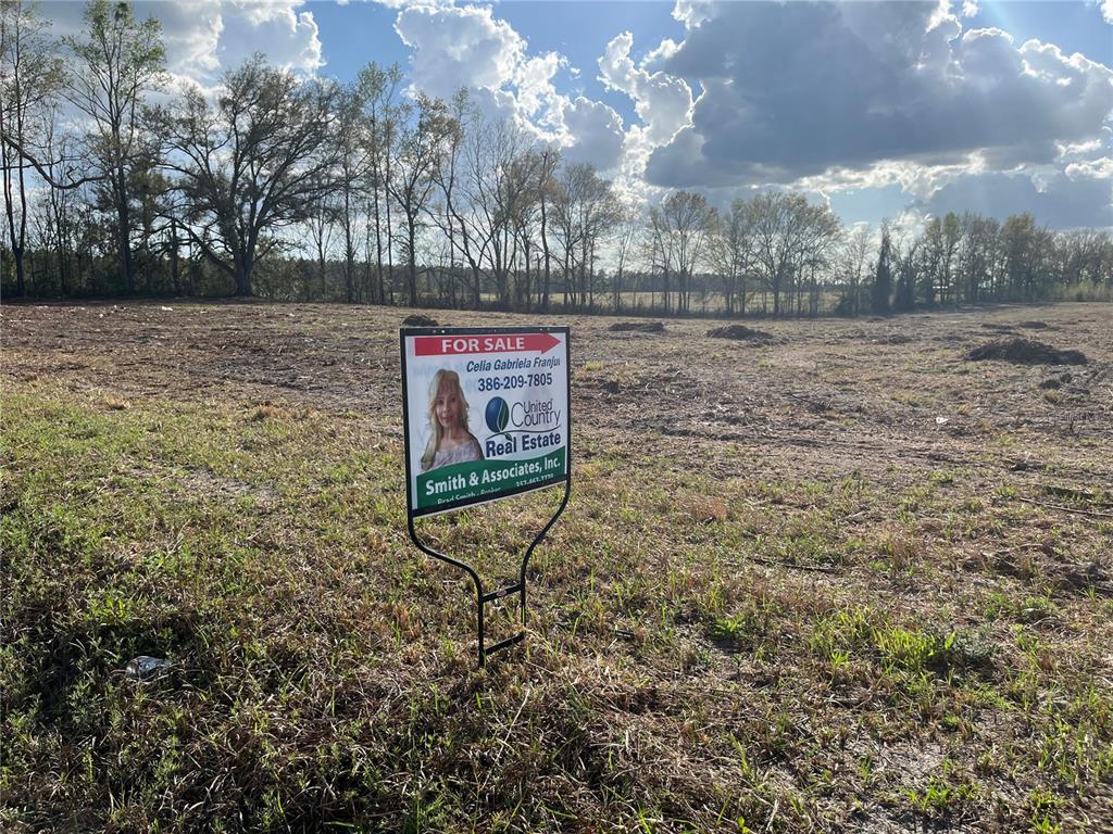 Tbd 185th Road Live Oak, FL 32060 - Photo 1 of 17 a sign board with empty space and wooden fence