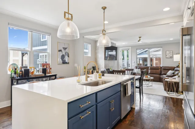 a kitchen with a sink a counter space appliances and cabinets