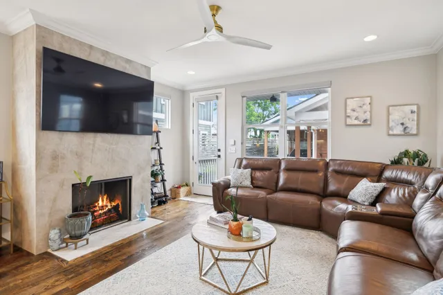 a living room with furniture a flat screen tv and a fireplace