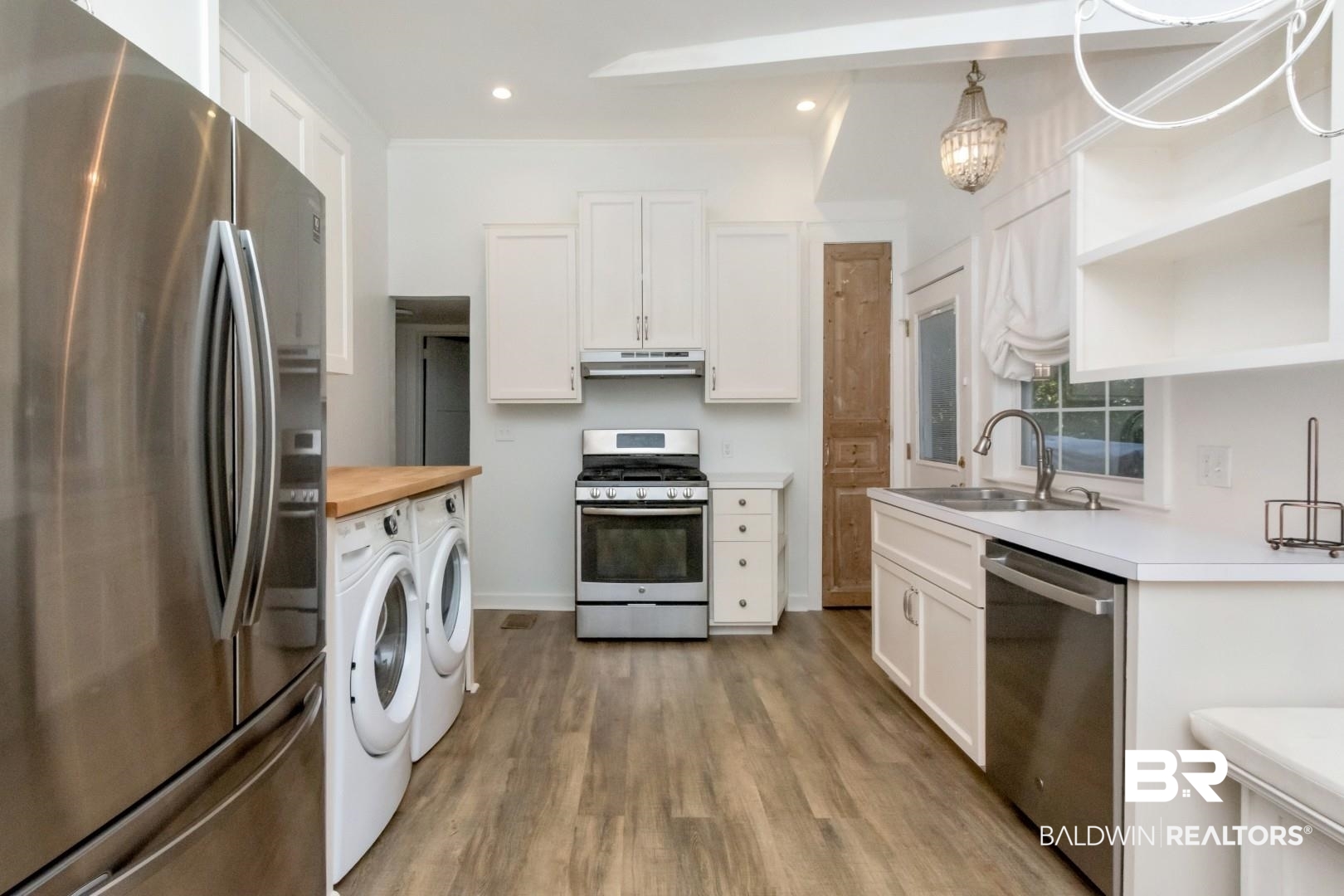 16 Princess Anne Road Mobile, AL 36608 - Photo 13 of 40 Kitchen with appliances with stainless steel finishes, open shelves, white cabinetry, light wood-style flooring, and recessed lighting