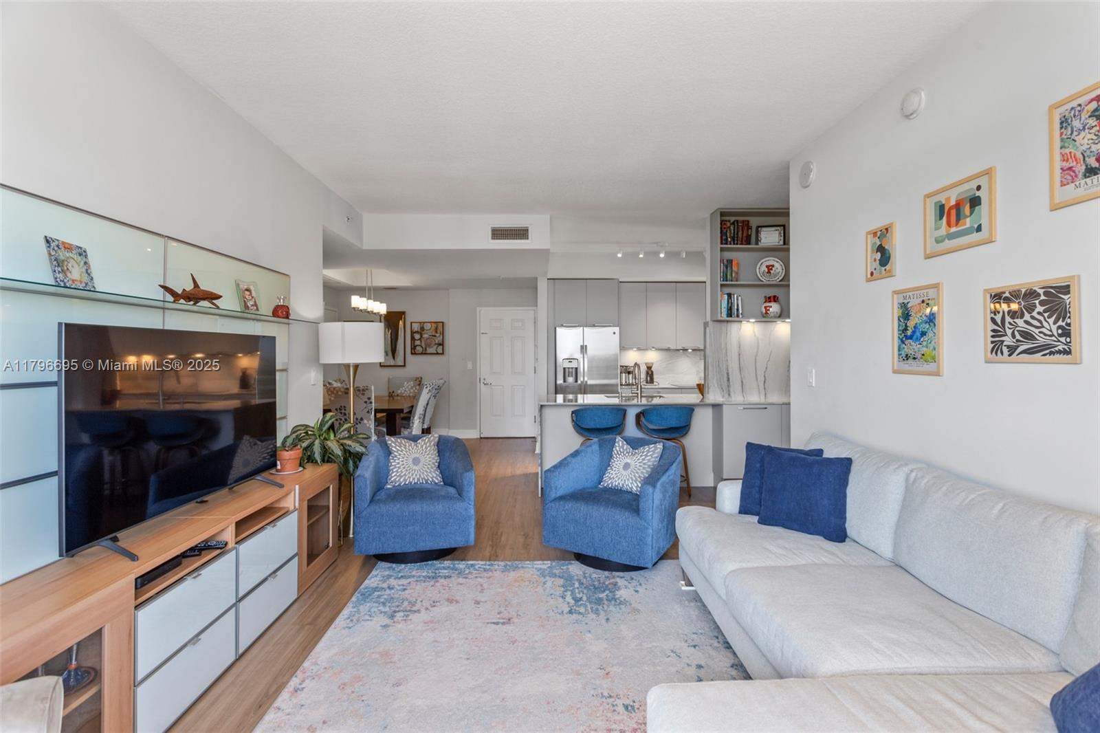 3232 Southwest 22nd Street, Unit 601 Miami, FL 33145 - Photo 11 of 38 a living room with furniture and a flat screen tv