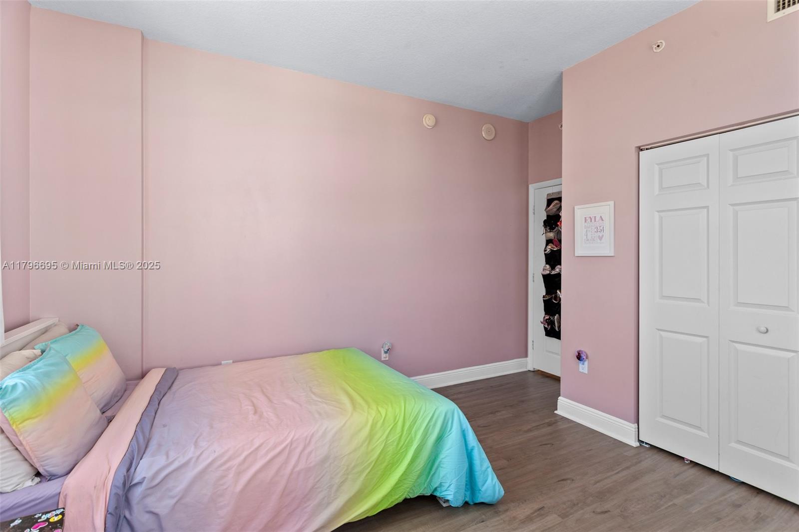 3232 Southwest 22nd Street, Unit 601 Miami, FL 33145 - Photo 19 of 38 a bedroom with a bed and a wall painting