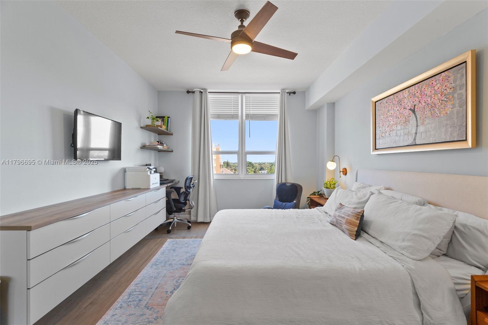 3232 Southwest 22nd Street, Unit 601 Miami, FL 33145 - Photo 20 of 38 a bedroom with a large bed and a chandelier