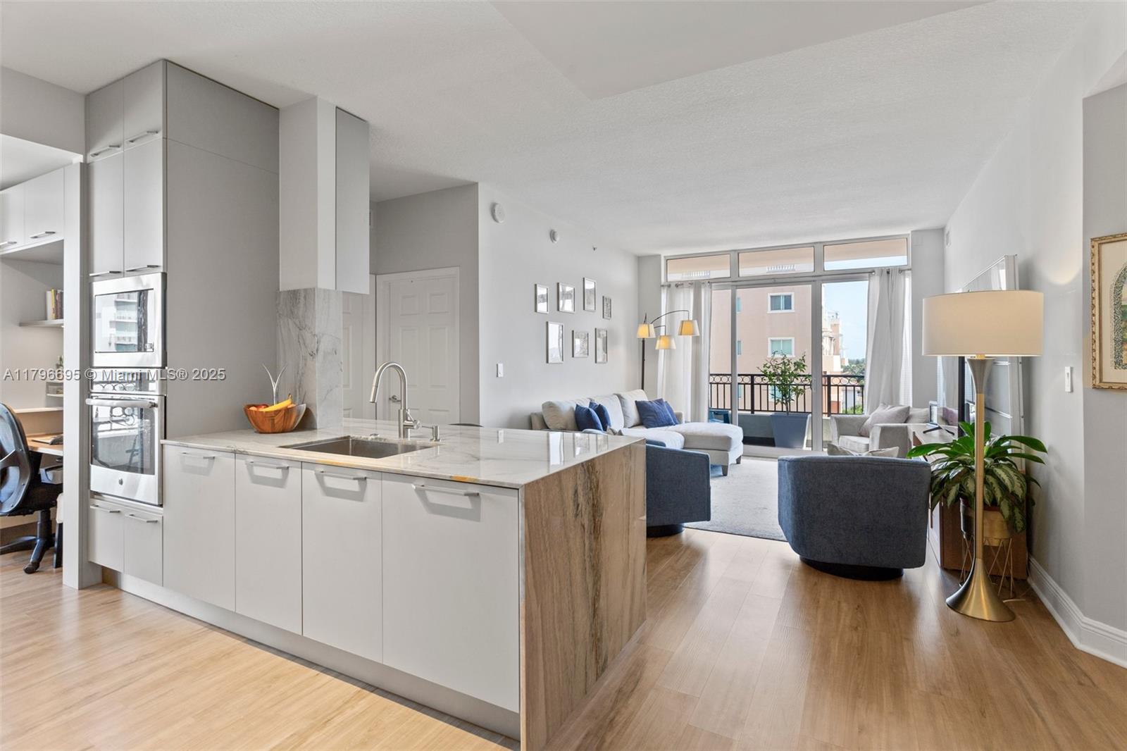 3232 Southwest 22nd Street, Unit 601 Miami, FL 33145 - Photo 2 of 38 a living room with furniture a wooden floor and a sink
