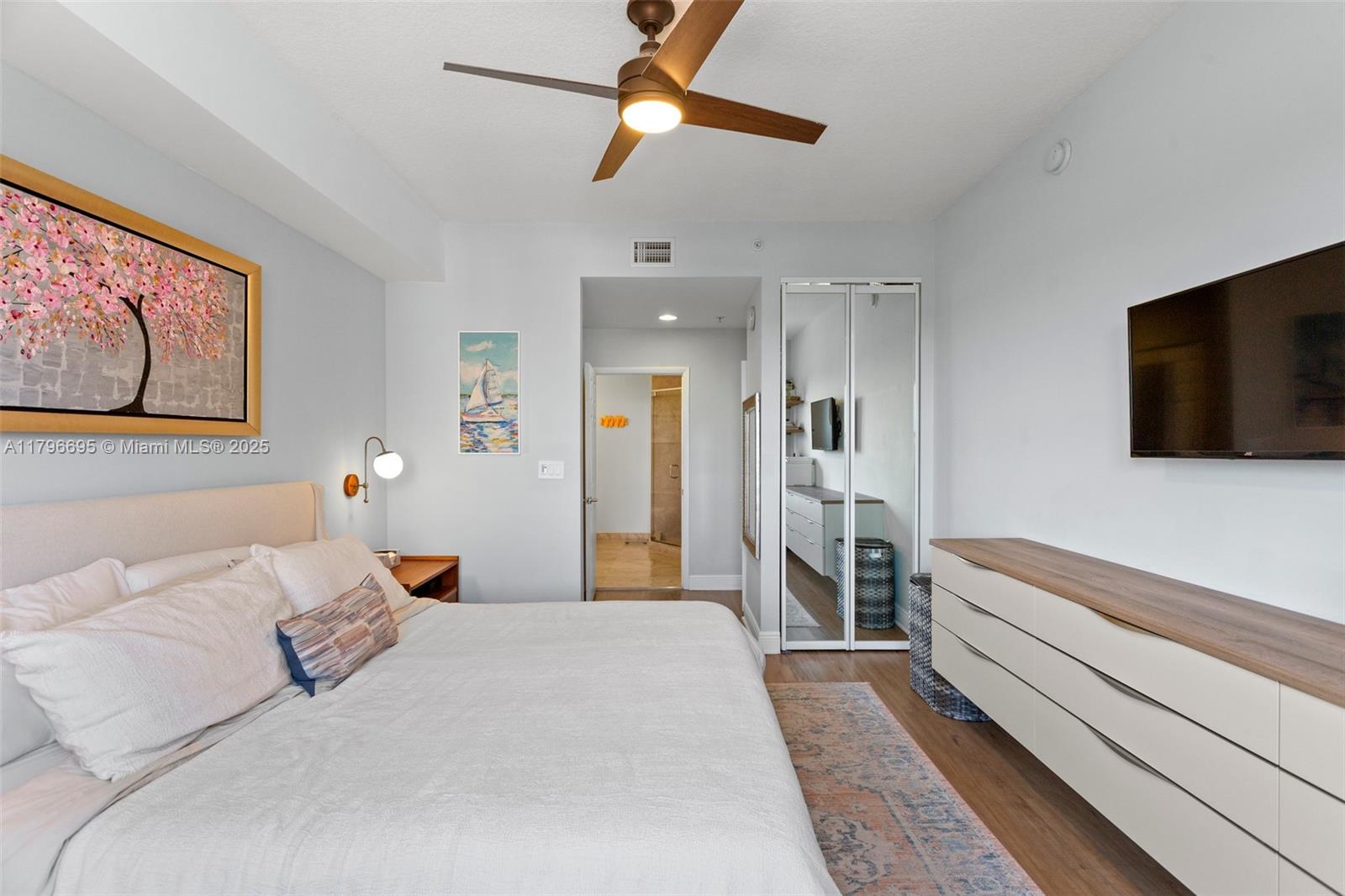 3232 Southwest 22nd Street, Unit 601 Miami, FL 33145 - Photo 22 of 38 a bedroom with a bed and a flat screen tv