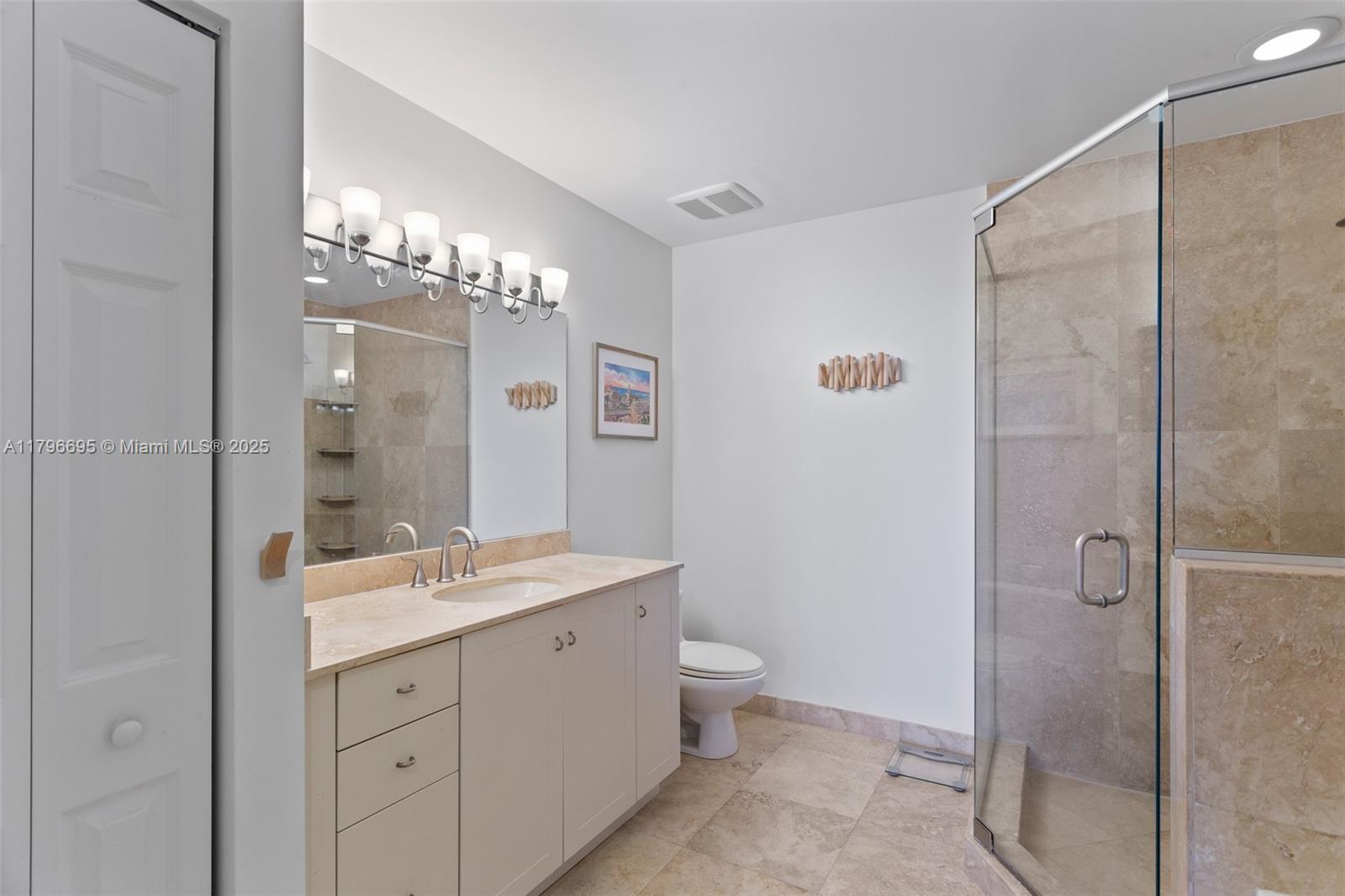 3232 Southwest 22nd Street, Unit 601 Miami, FL 33145 - Photo 23 of 38 a spacious bathroom with a double vanity sink mirror and toilet