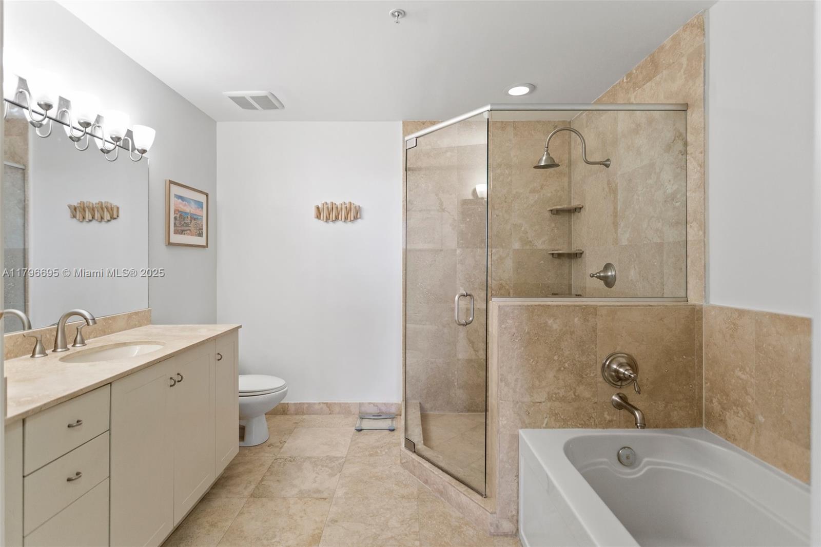 3232 Southwest 22nd Street, Unit 601 Miami, FL 33145 - Photo 24 of 38 a bathroom with a tub sink toilet and mirror