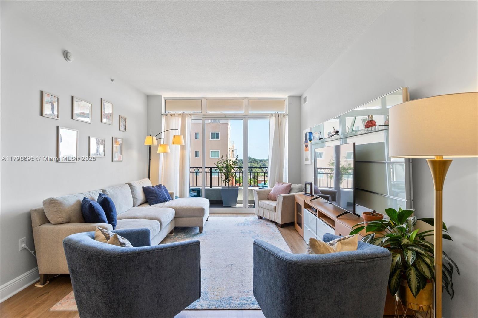 3232 Southwest 22nd Street, Unit 601 Miami, FL 33145 - Photo 3 of 38 a living room with furniture and a flat screen tv