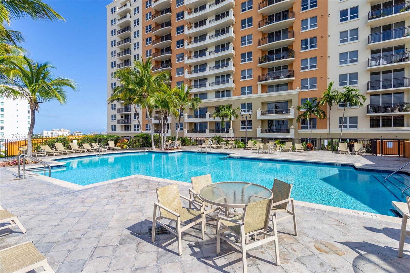 3232 Southwest 22nd Street, Unit 601 Miami, FL 33145 - Photo 37 of 38 a view of a swimming pool with a lounge chairs