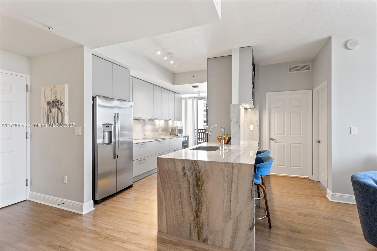 3232 Southwest 22nd Street, Unit 601 Miami, FL 33145 - Photo 6 of 38 a kitchen view with stainless steel appliances a refrigerator and a table